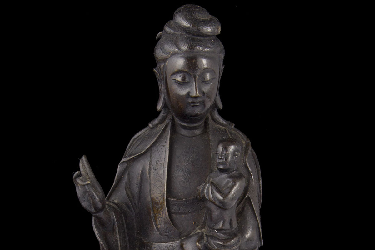 Guanyin holding Buddha