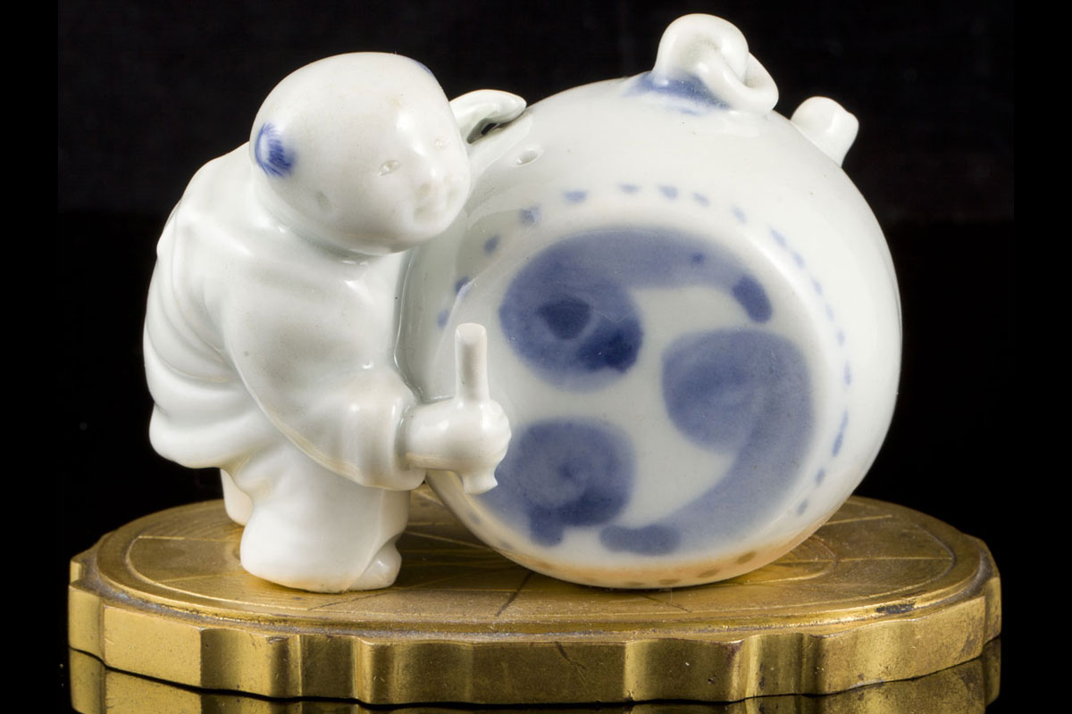 A Japanese blue and white ihirado figure of a young-boy-and-drum-shaped water dropper mounted on a European gilt bronze base 